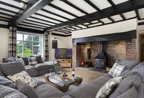 Ground floor: Spacious sitting room with inglenook fireplace and wood burning stove