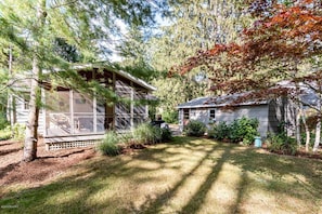 Screened porch overlooking private backyard yard 