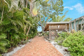 Pathway from parking area to back of home where bungalows are