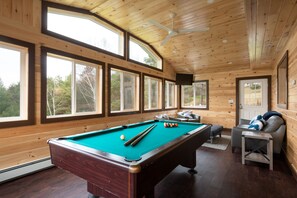 Heated 4 season room w/ pool table, sofa, chairs and TV