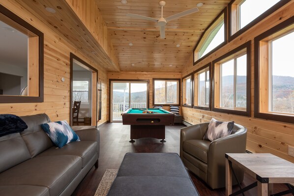Heated 4 season room w/ pool table, sofa, chairs and TV