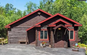 Exterior shot of Guest House at Eagles Landing. Large paved parking lot.