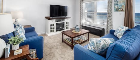 Living Room - Spacious living room with flat screen TV and queen sized sleeper sofa