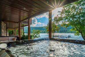 Unwind in the bubbling, lakefront hot tub at the end of each day.