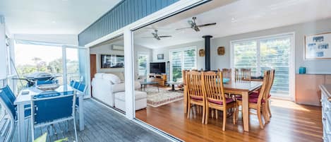 Glass folding doors open out to balcony