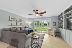 Open concept living room that leads straight to the screened in porch