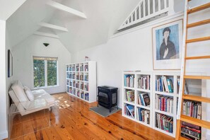 Cozy reading corner with bookshelves and sofabed