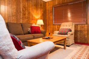 bright living room with pull out queen couch