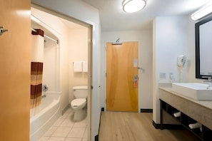 Bathroom with a shower and tub. The essential toiletries and towels are provided