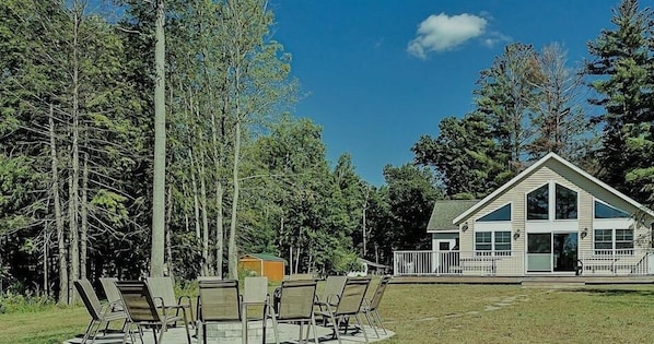 Fire pit area between the home & the lake