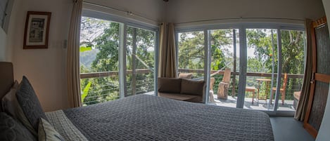 The comfort of a king sized bed with a tree house view.