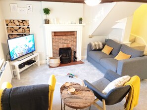 Living room with traditional fireplace, modern 4K Sony TV, Google Chromecast