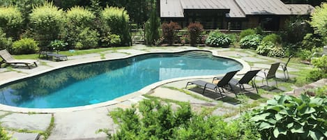42 foot, heated saline pool is surrounded by mature perennial gardens. 