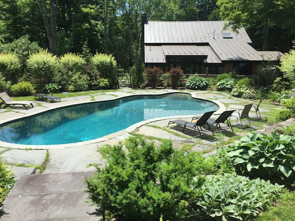 42 foot, heated saline pool is surrounded by mature perennial gardens. 