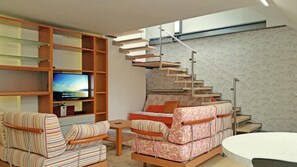 Living room with sofa bed 130x200 beneath the stairs to the main bedroom