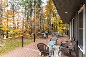 Admire the lush forest and lake views from the back deck