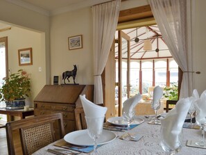 Attractive dining area with access to the conservatory | Rowan Cottage, Aviemore