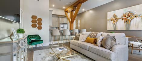 Open-concept living, kitchen, and dining area with plenty of seating. Enjoy a 65” Samsung Smart 4K TV with streaming and DIRECTV Entertainment. Dining table for four and lots of natural light!