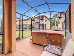 Enjoy the outdoors with a private patio featuring a soothing hot tub.