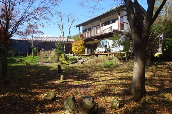 House and garden in mid autumn. The guest is the single-story on left.