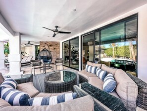 Outdoor covered Patio with fireplace and fans with great lounge seating options!