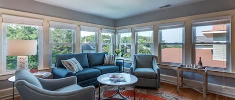 Spacious living room with large TV and lots of natural light