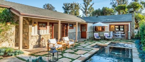 Relax near the pool in this backyard oasis