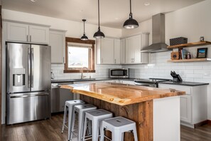 top end kitchen finishes with Montana wood slab island!