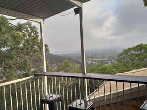 The balcony has  a breakfast bar, seating and great views