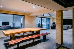 Enjoy alfresco dining at the large timber table, perfect for BBQs.
