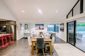 The open-plan living area is a bright and inviting space with plush seating, a fireplace, and seamless indoor-outdoor flow.