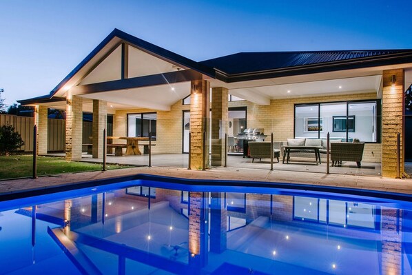 Dive into the private swimming pool, a great addition to cool off and enjoy the sunshine in the fenced backyard.