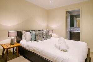 The primary bedroom includes a king-sized bed, walk-in robe, and private bathroom for added comfort.
