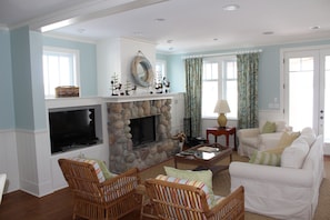 Open living room w/ wood burning fireplace