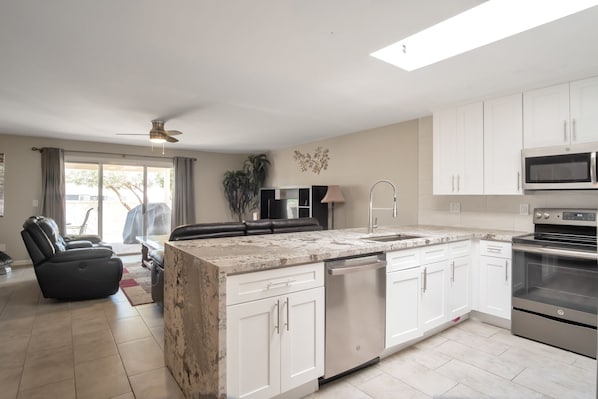 Gorgeous open kitchen with new cabinets and granite - waterfall edge!