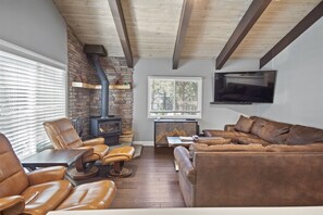 Living room with woodstove and large TV