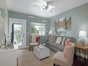 Living area - includes a sleeper sofa, flat screen TV and overlooks the Intracoastal.