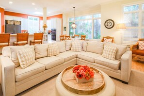 There is an open floor plan layout between the den, kitchen dining area and kitchen.