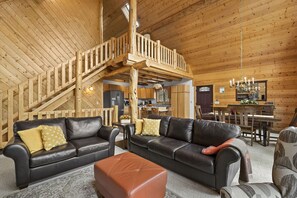 Living room with dining room, kitchen and loft in background