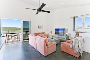 The living area opens onto the spacious balcony