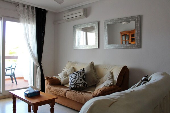 Spacious living room with balcony and views