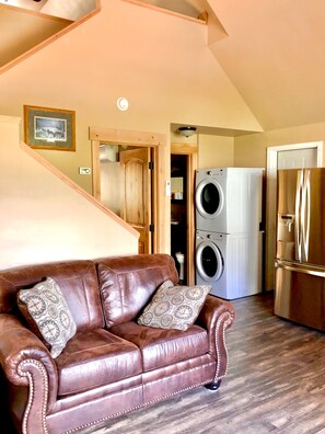 stairs to the lofted bedroom are behind the couch