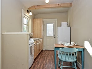 Looking through kitchen area to side door from the front door