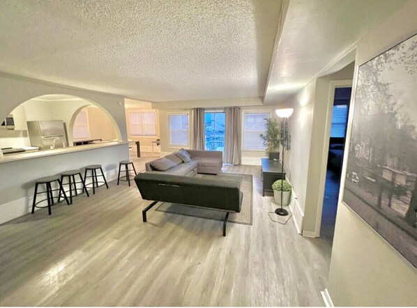 Big living room connecting to kitchen and dining room , balcony.