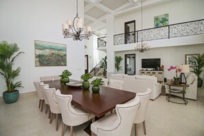 Open concept dining room (table for 12) and living room with coffered ceiling.