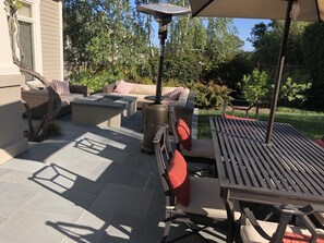 Inviting fire pit with couches and dining table in the foreground