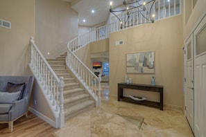 Lovely front entrance and foyer with formal living room to the left of staircase.