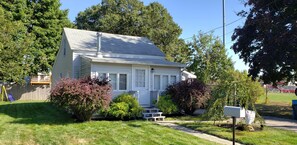 Dead end street and large yard with a backyard fire pit and patio