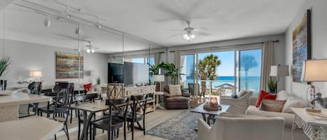 Spacious living and dining area overlooking the beach and theGulf of Mexico