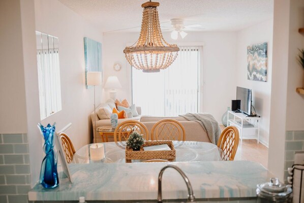 Look out from the wave-themed kitchen into the coastal dining and living room.